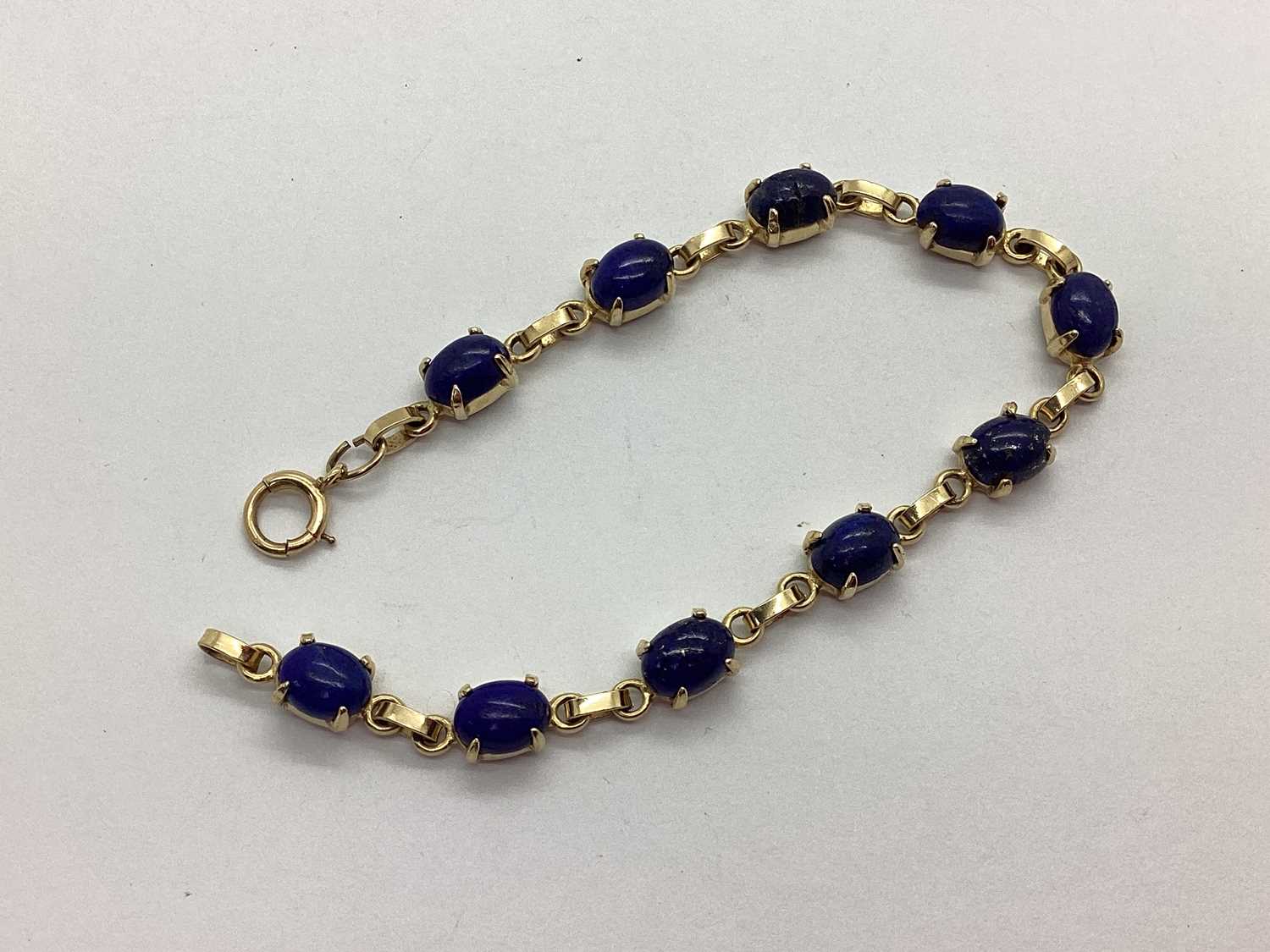Lot 75 - A Lapis Lazuli Set Line Bracelet, uniform oval...