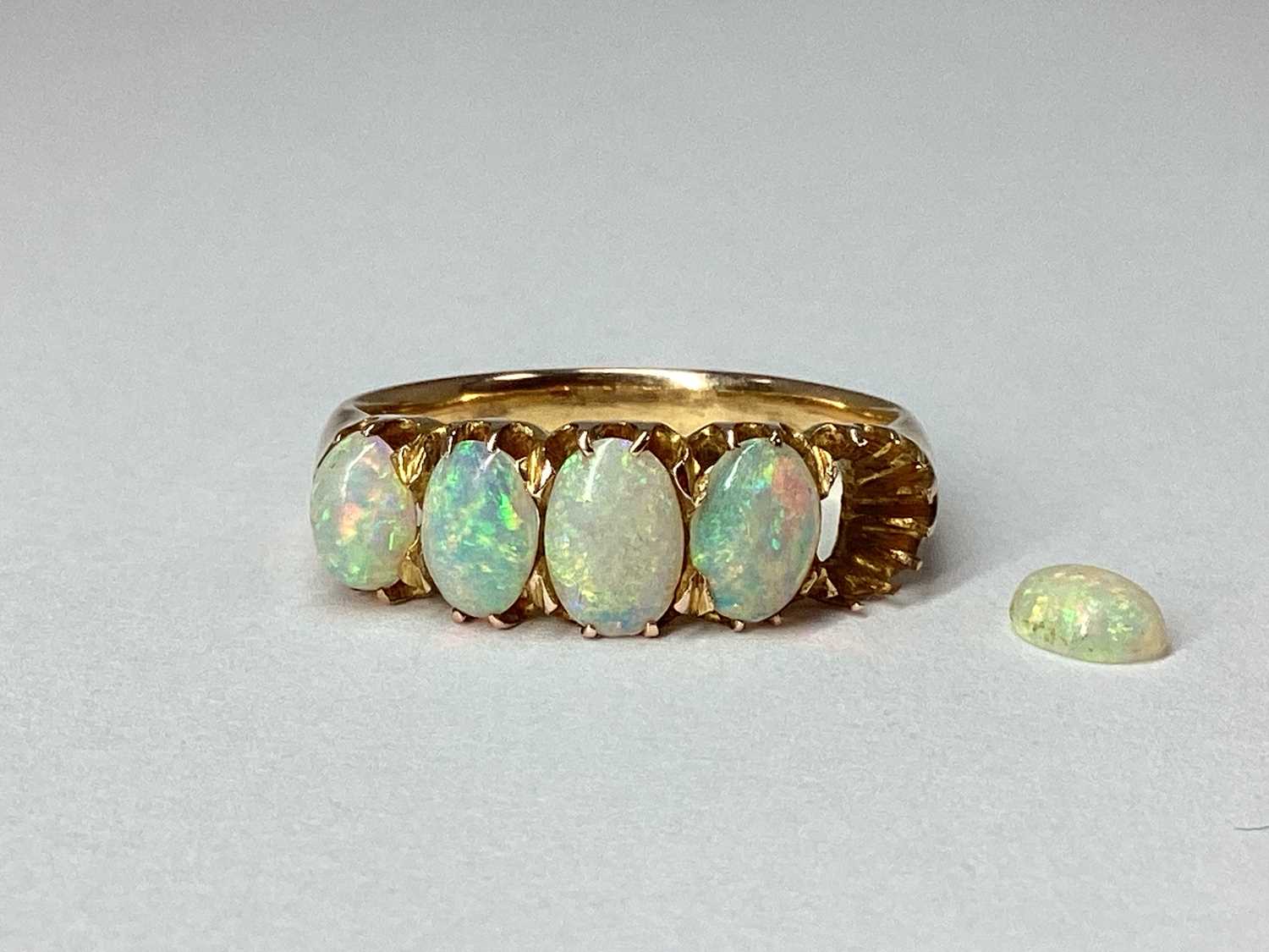 Lot 92 - A Five Stone Opal Ring, graduated claw set...
