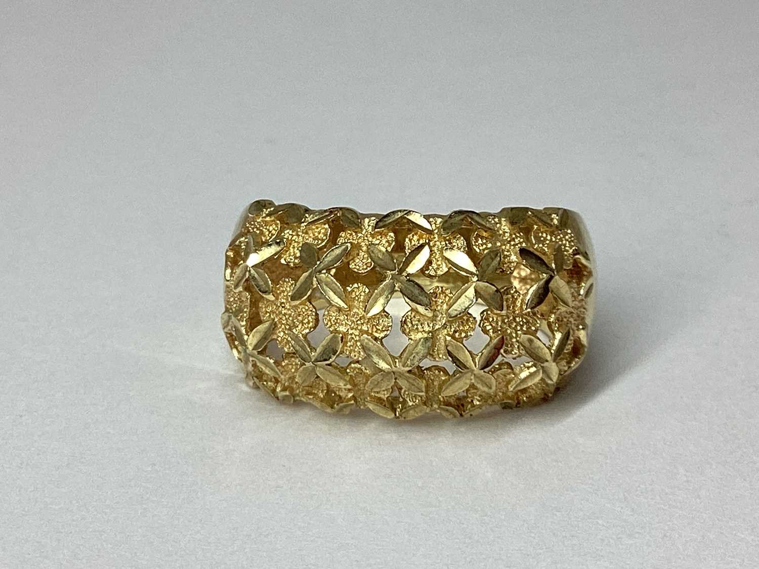 Lot 88 - QVC; A Wide 9ct Gold Openwork Band, of floral...