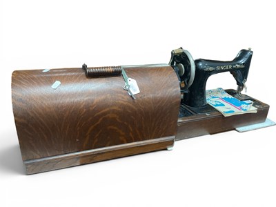 Lot 1512 - A Singer Sewing Machine (cased).