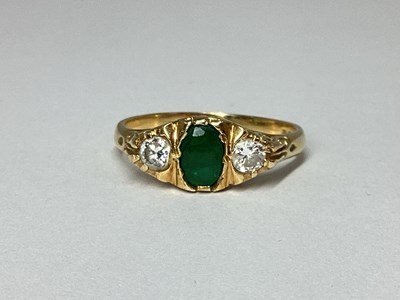 Lot 83 - An 18ct Gold Three Stone Emerald and Diamond...