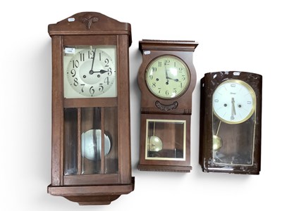 Lot 1516 - Three vintage wooden cased wall clocks,...