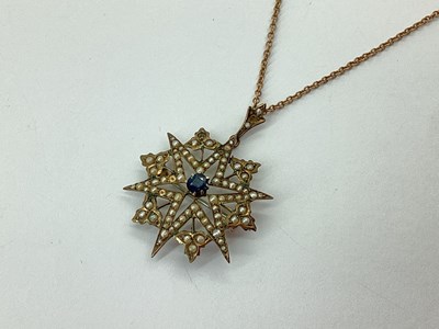 Lot 99 - An Edwardian Seed Pearl Inset Starburst Style...