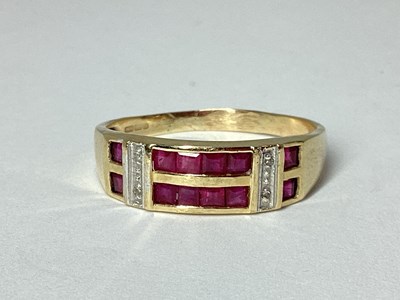 Lot 61 - A Modern 9ct Gold Channel Set Ring, the two...