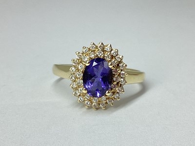Lot 53 - A Modern Cluster Ring, oval four claw centre,...